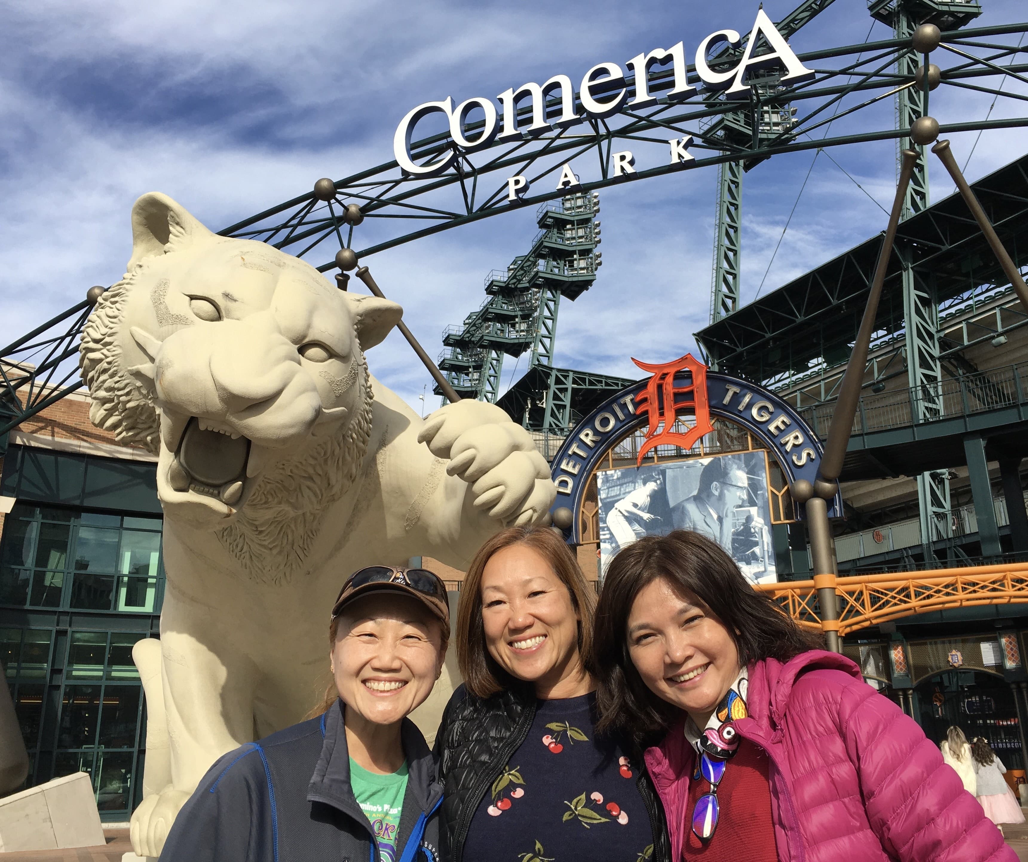 Tour guests visiting Detroit pose in front of the giant tiger outside of Comerica Park, home of the Detroit Tigers.